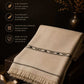 Lamb Wool Shawl in soft beige wool with black decorative stripes and fringed edges, showcasing premium natural texture and warmth
