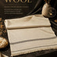Lamb Wool Shawl in soft beige with subtle decorative border and fringed edges, showcasing premium natural wool fabric